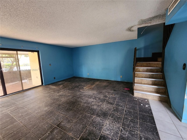 unfurnished living room with a textured ceiling