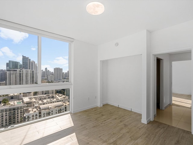 unfurnished room with hardwood / wood-style floors