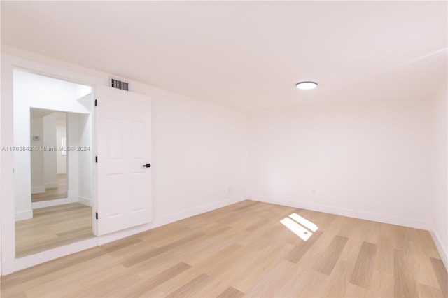 empty room with light hardwood / wood-style floors