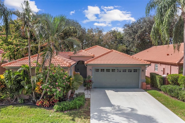 mediterranean / spanish-style house with a garage