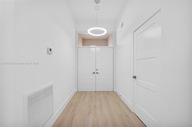 hall with light hardwood / wood-style floors