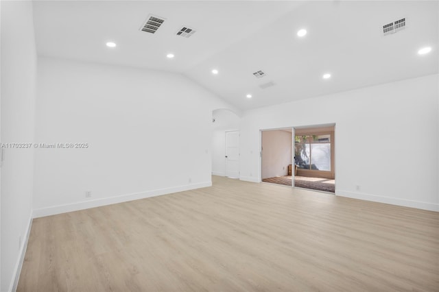 unfurnished room featuring light hardwood / wood-style flooring and lofted ceiling