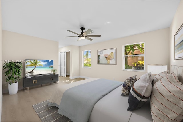 bedroom with ceiling fan and hardwood / wood-style floors