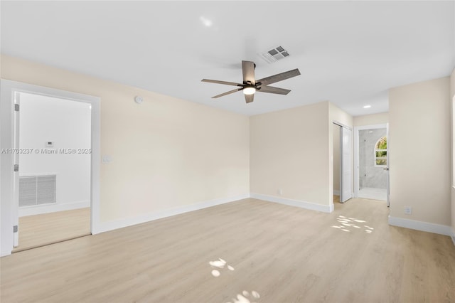 spare room featuring ceiling fan and light hardwood / wood-style floors