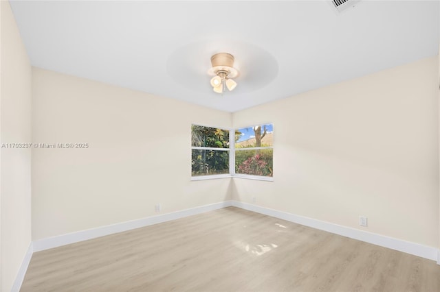 spare room with ceiling fan and light wood-type flooring