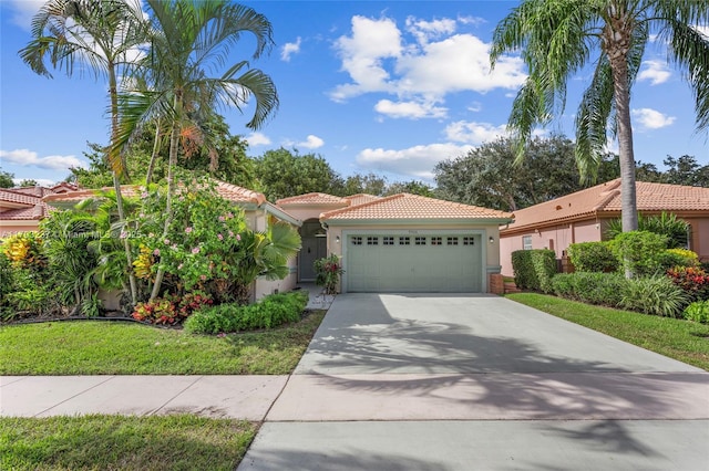 mediterranean / spanish house featuring a garage and a front lawn