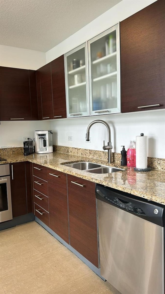 41 SE 5th St Unit 2011, Miami, FL 33131 - kitchen with stainless steel appliances, a sink, light stone counters, modern cabinets, and glass insert cabinets