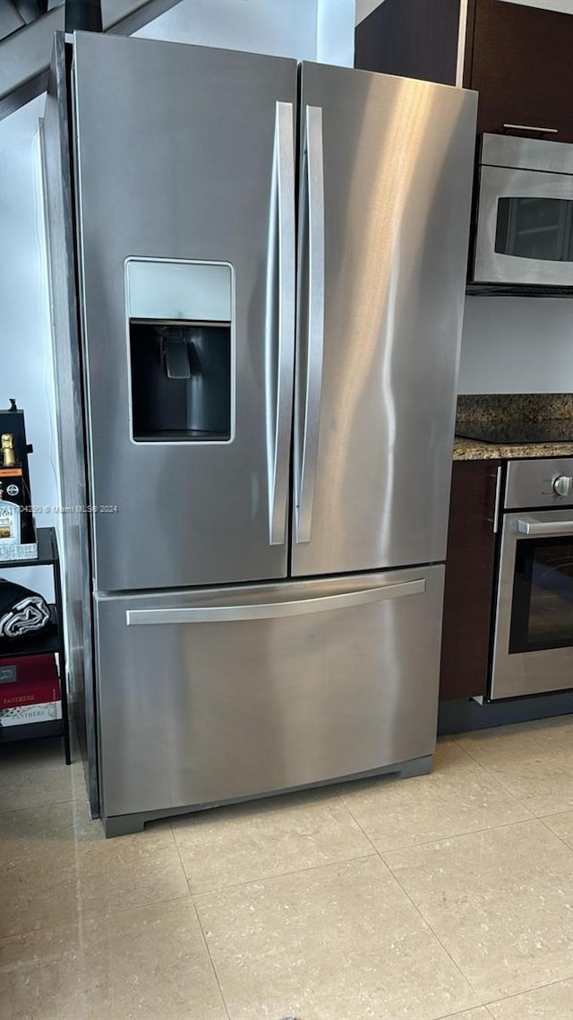 41 SE 5th St Unit 2011, Miami, FL 33131 - kitchen view of appliances with stainless steel finishes, dark brown cabinets, and dark stone counters