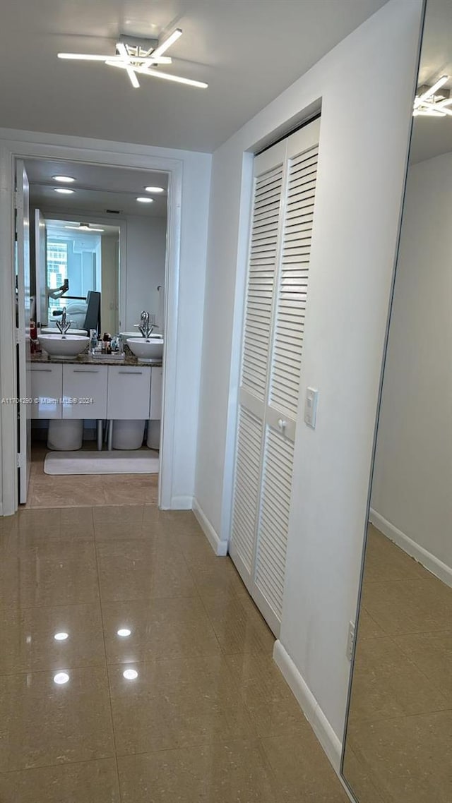 41 SE 5th St Unit 2011, Miami, FL 33131 - hall featuring a sink, baseboards, an office area, and tile patterned flooring