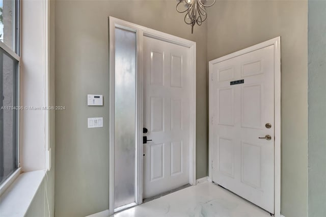 foyer entrance with a chandelier