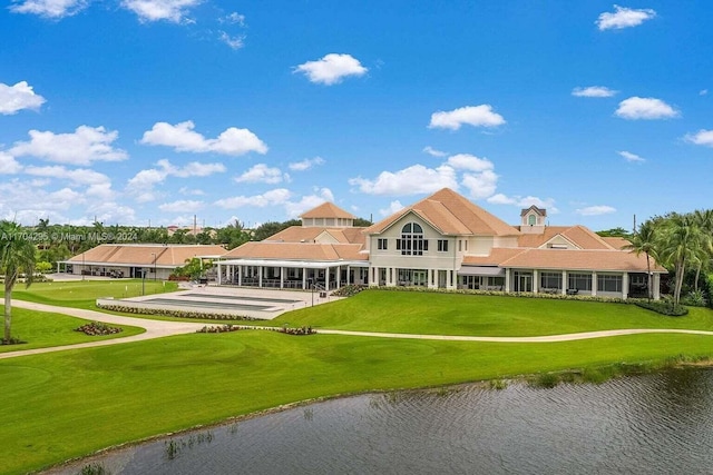 back of property featuring a yard and a water view