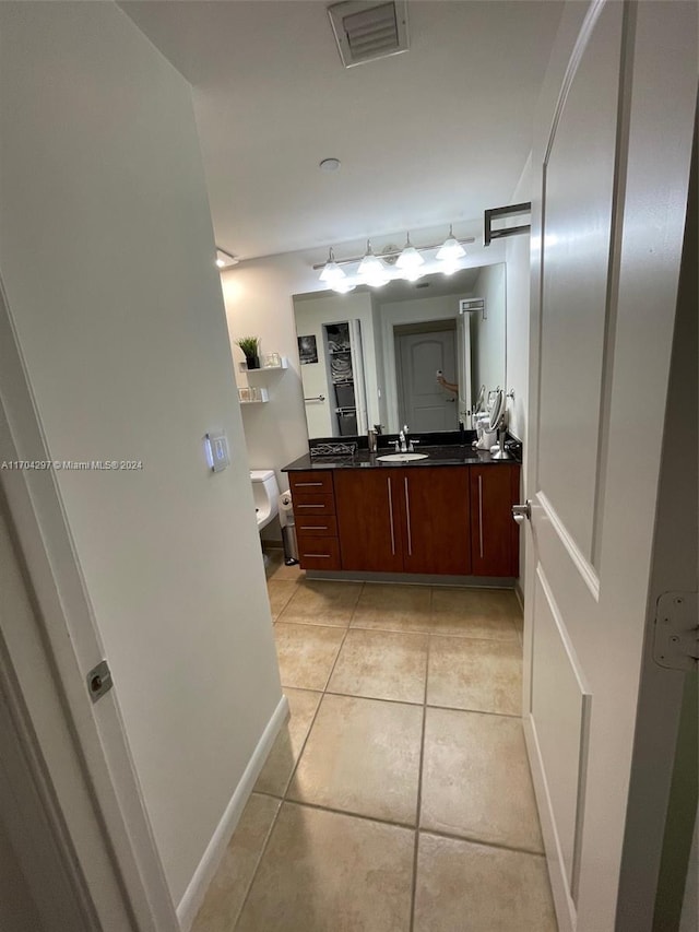 bathroom with tile patterned floors, vanity, and toilet