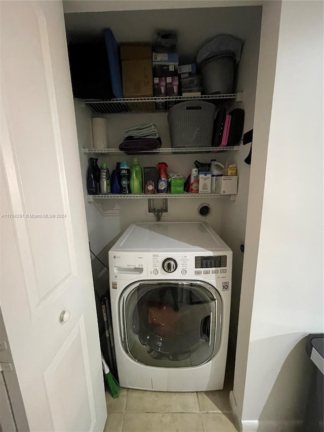 washroom with light tile patterned floors and washer / dryer