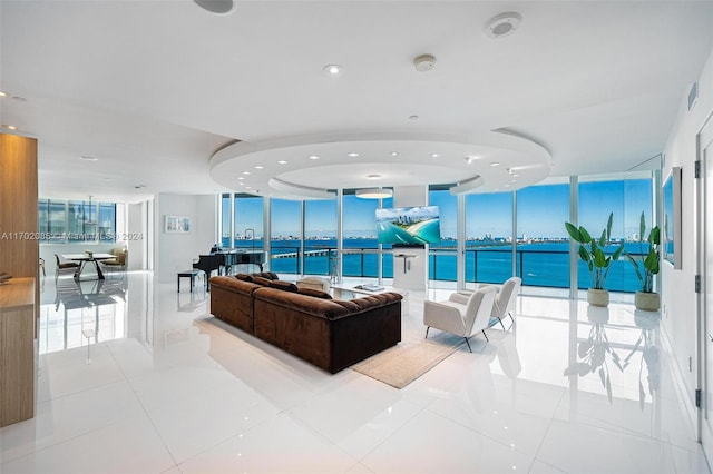 living room featuring plenty of natural light, light tile patterned flooring, and a wall of windows