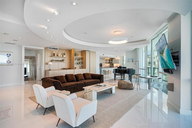 living room with a raised ceiling and a wealth of natural light