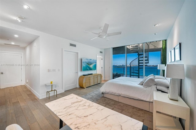 bedroom with hardwood / wood-style flooring, ceiling fan, and access to exterior