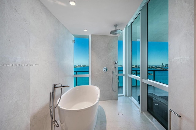 bathroom with a water view, plus walk in shower, and tile walls