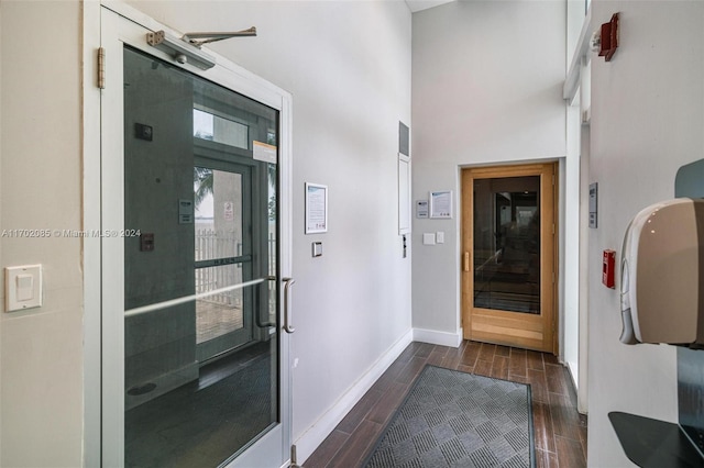 interior space with dark wood-type flooring and a high ceiling