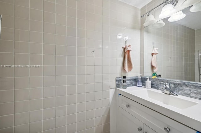 bathroom with backsplash, vanity, and tile walls