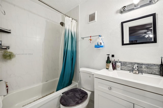 full bathroom featuring shower / bath combo with shower curtain, vanity, a textured ceiling, and toilet