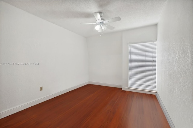 spare room with hardwood / wood-style floors, ceiling fan, and a textured ceiling