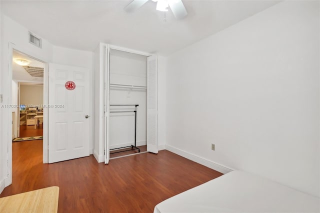 bedroom featuring hardwood / wood-style floors, ceiling fan, and a closet