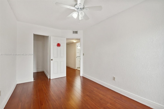 unfurnished room featuring ceiling fan and dark wood-type flooring