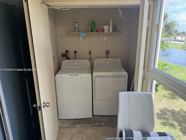 washroom featuring washer and dryer and a water view