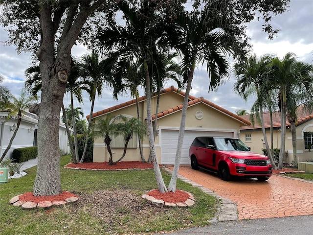 view of front of home with a garage and a front lawn