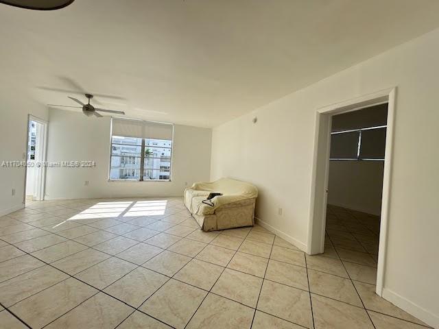 unfurnished room featuring ceiling fan and light tile patterned floors