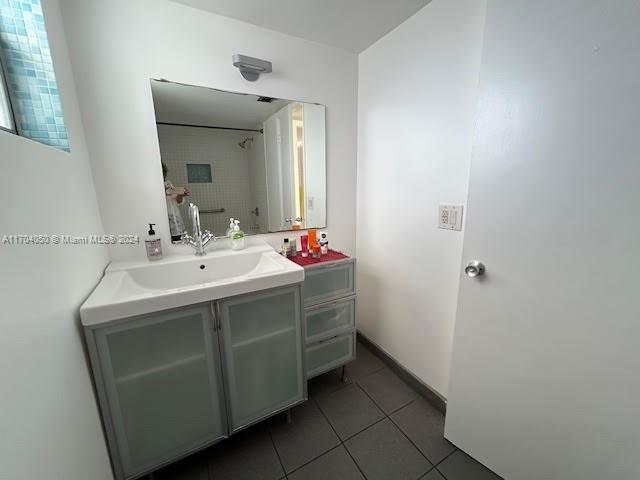 bathroom with tile patterned floors and vanity