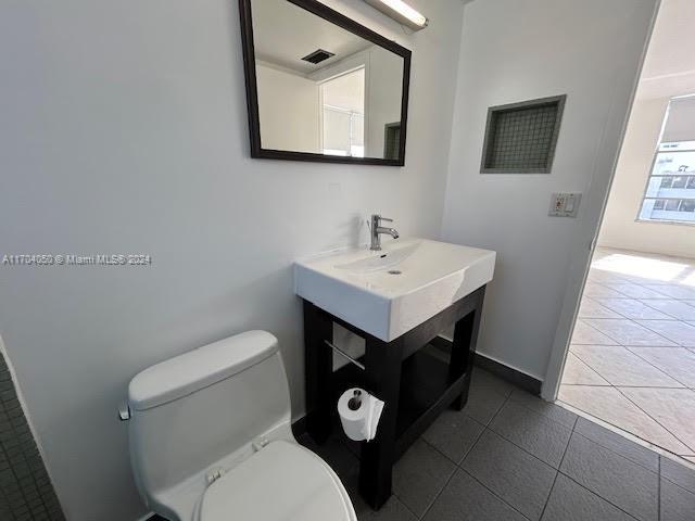 bathroom featuring tile patterned flooring and toilet