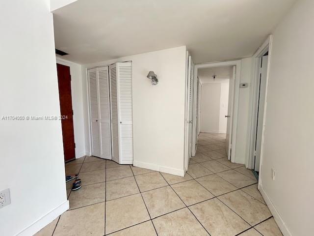 corridor featuring light tile patterned floors