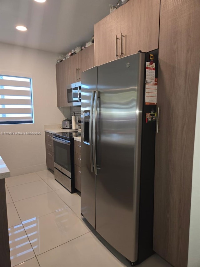 kitchen featuring appliances with stainless steel finishes and light tile patterned floors