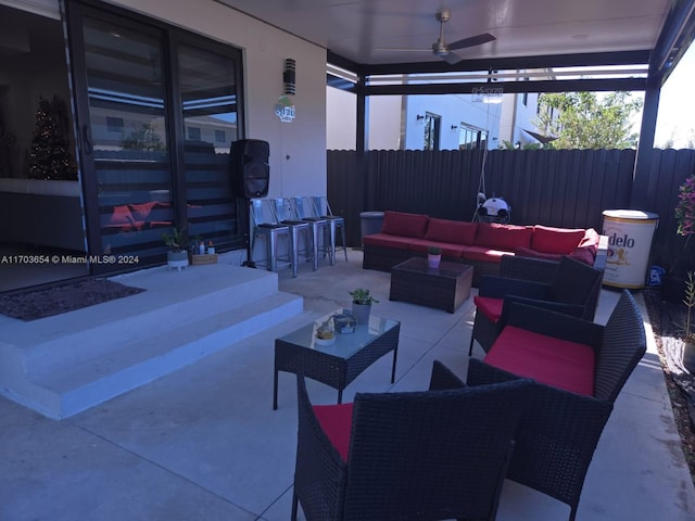 view of patio / terrace featuring an outdoor living space, ceiling fan, and an outdoor bar