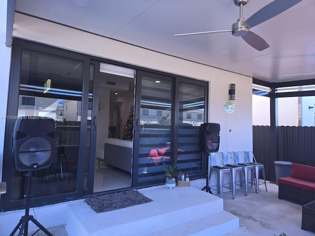 doorway to property featuring ceiling fan