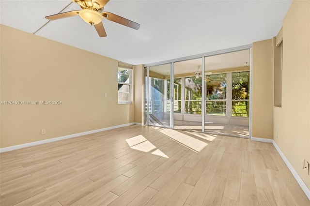 spare room with light hardwood / wood-style floors and ceiling fan