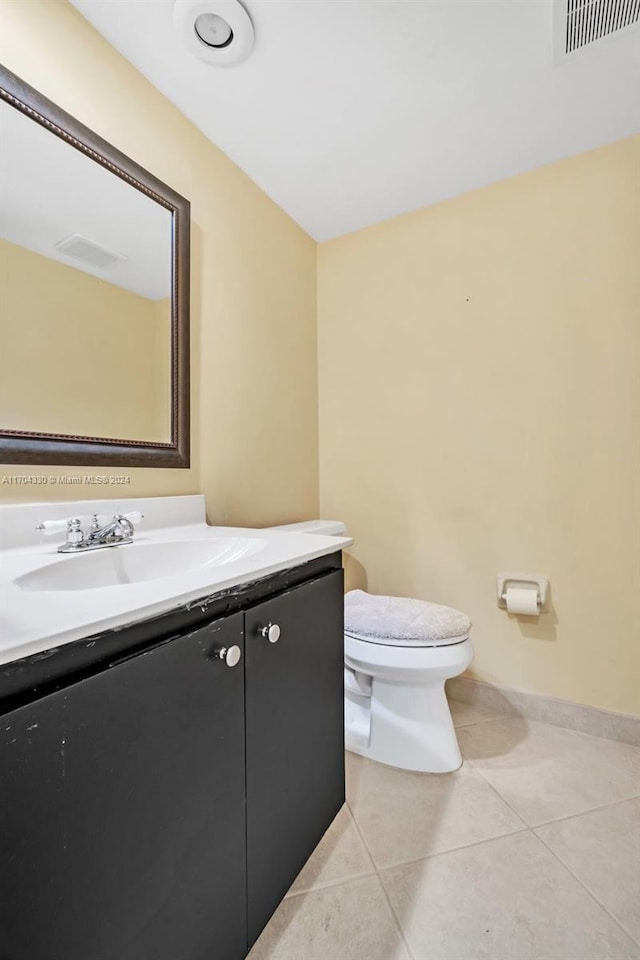 bathroom featuring tile patterned floors, vanity, and toilet