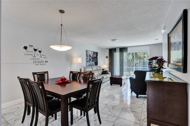 dining space featuring a textured ceiling