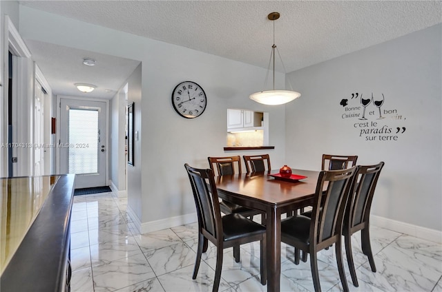 dining room featuring a textured ceiling