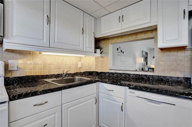 kitchen with white cabinetry, dishwasher, a drop ceiling, sink, and backsplash