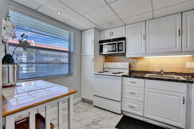 kitchen featuring electric range, white cabinetry, and backsplash