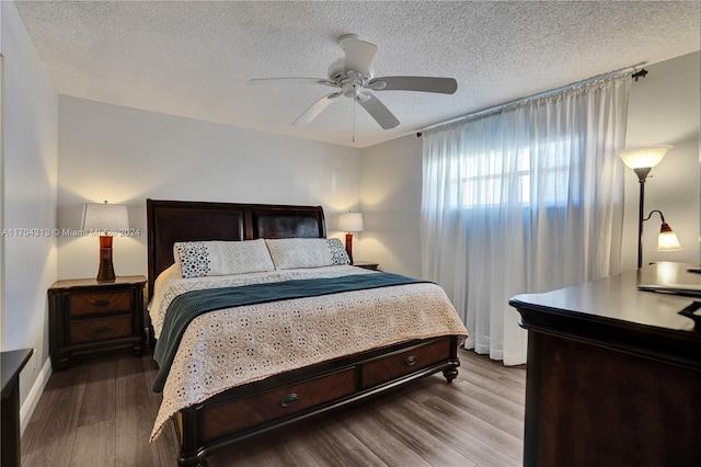 bedroom featuring wood-type flooring, a textured ceiling, and ceiling fan