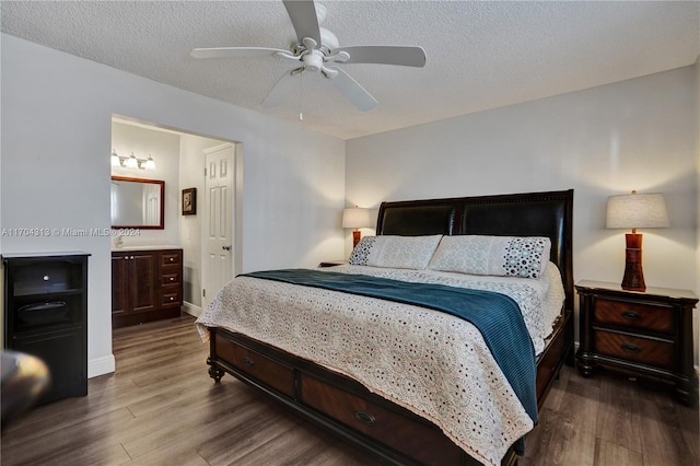 bedroom with hardwood / wood-style floors, a textured ceiling, ensuite bath, and ceiling fan