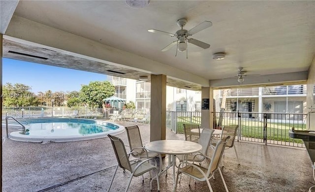 view of patio / terrace with ceiling fan and a fenced in pool