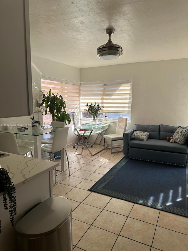 living room featuring light tile patterned floors and a textured ceiling