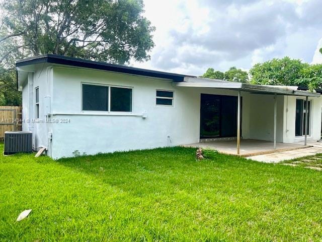 back of house featuring a yard, cooling unit, and a patio area