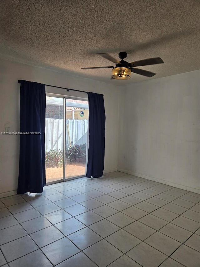 spare room featuring ceiling fan and light tile patterned floors