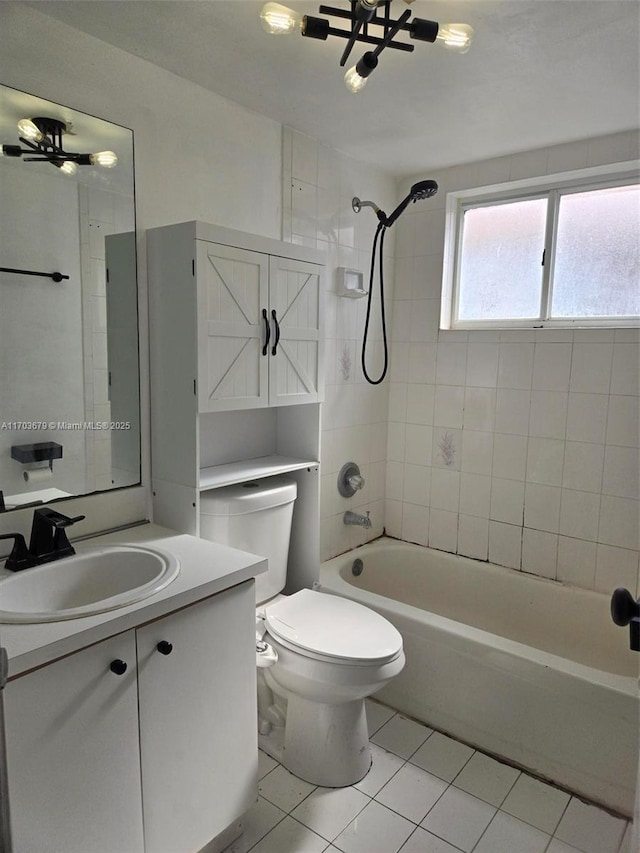 full bathroom featuring ceiling fan, tiled shower / bath combo, tile patterned flooring, toilet, and vanity