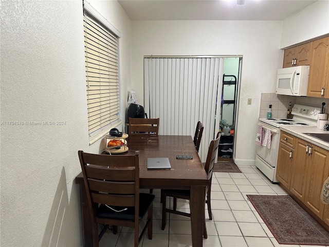 1838 NW 18th St, Miami, FL 33125 - kitchen with white appliances, light tile patterned floors, and light countertops